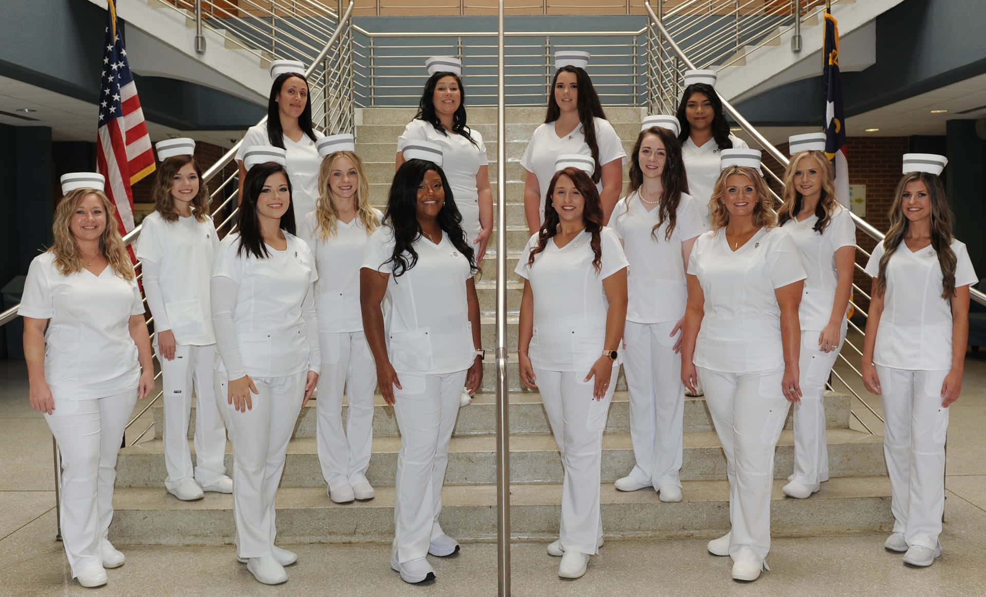 A Group Of Female Nurses Standing On Stairs