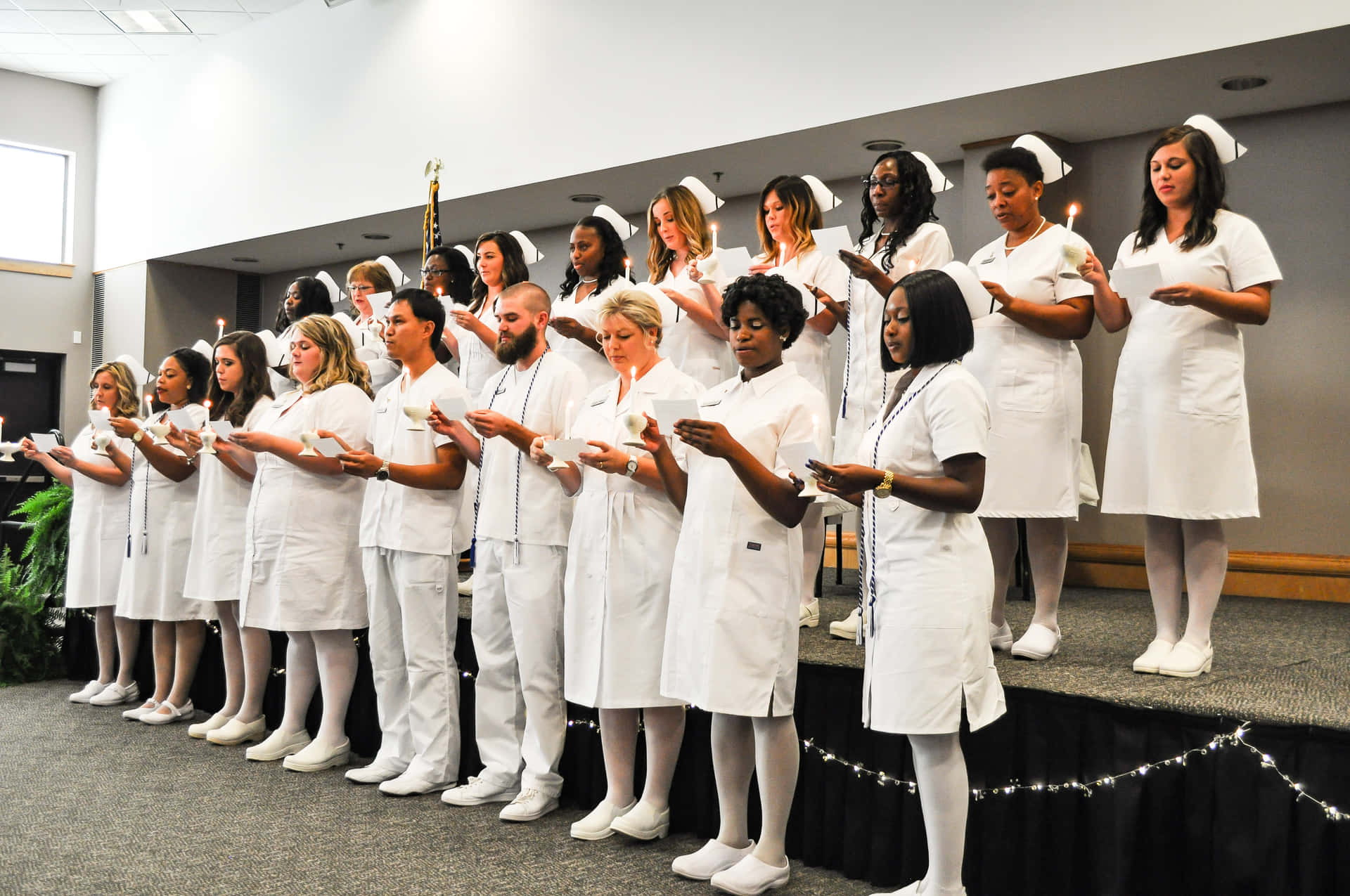 A Group Of Nurses Standing On Stage