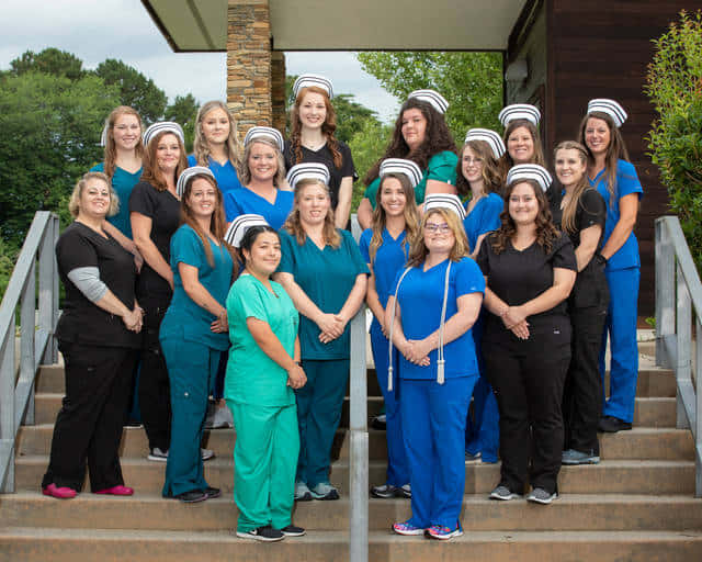 A Group Of Women In Scrubs Posing For A Photo