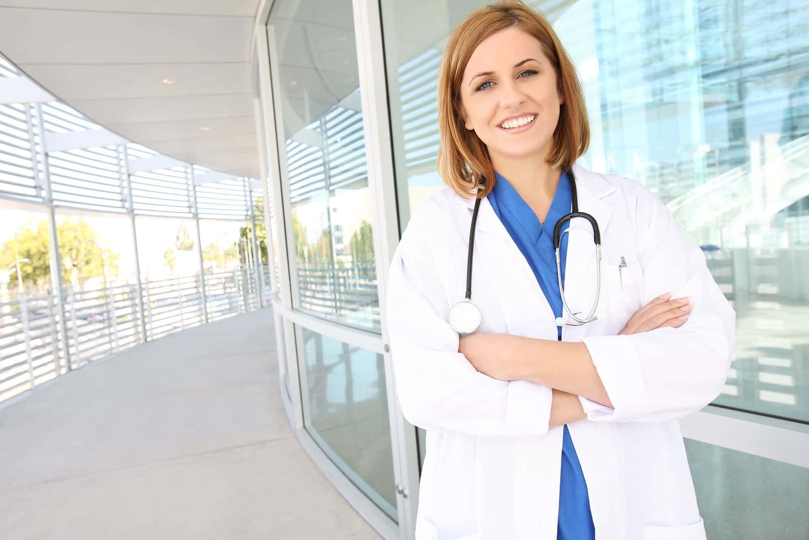 A Female Doctor Standing In Front Of A Building