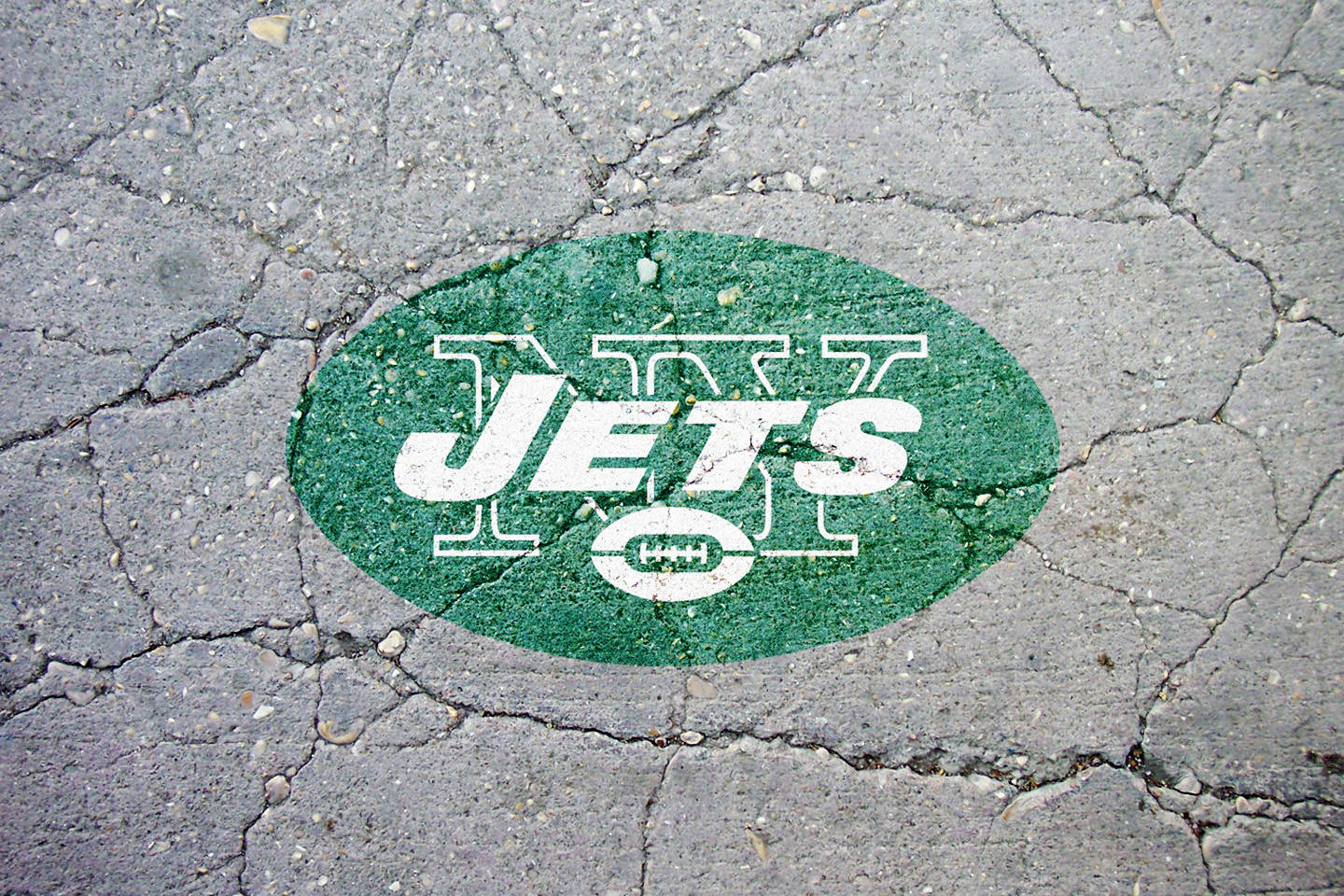 Logode Los Ny Jets En Un Pavimento Agrietado. Fondo de pantalla