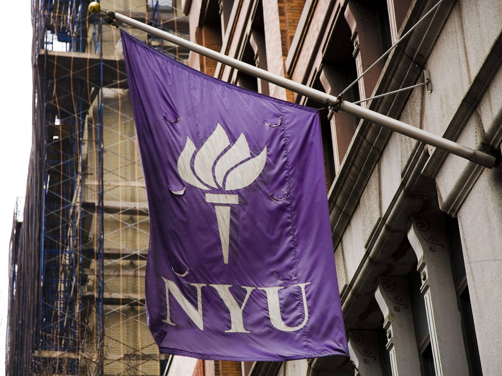 NYU Hanging Sign On A Pole Wallpaper