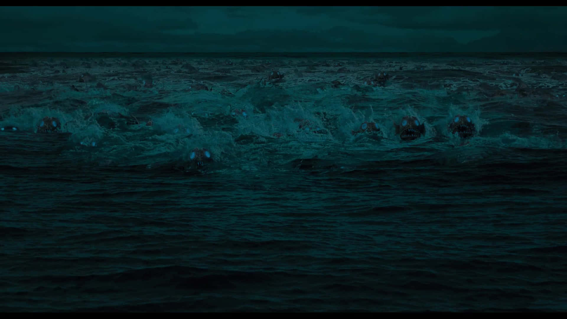 A Group Of People In The Ocean With A Dark Background