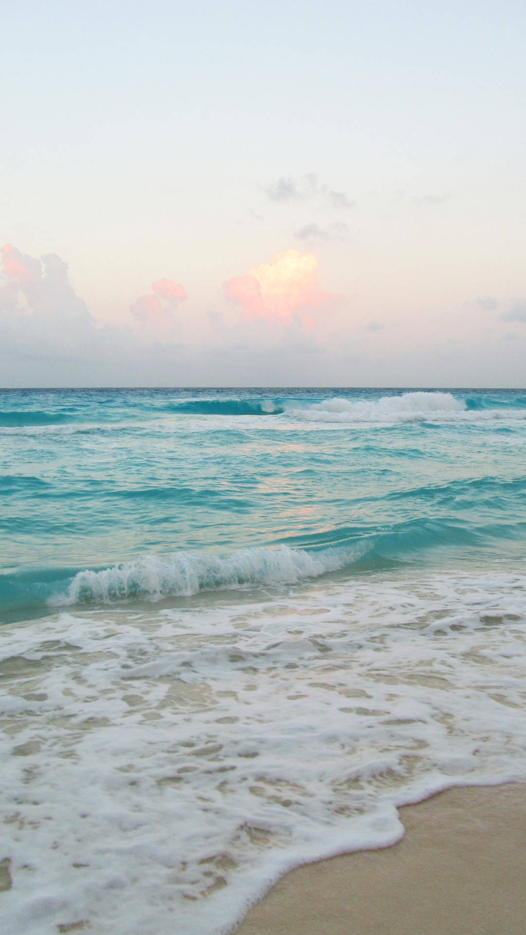 A stunning ocean wave overlooking a beautiful beach. Wallpaper