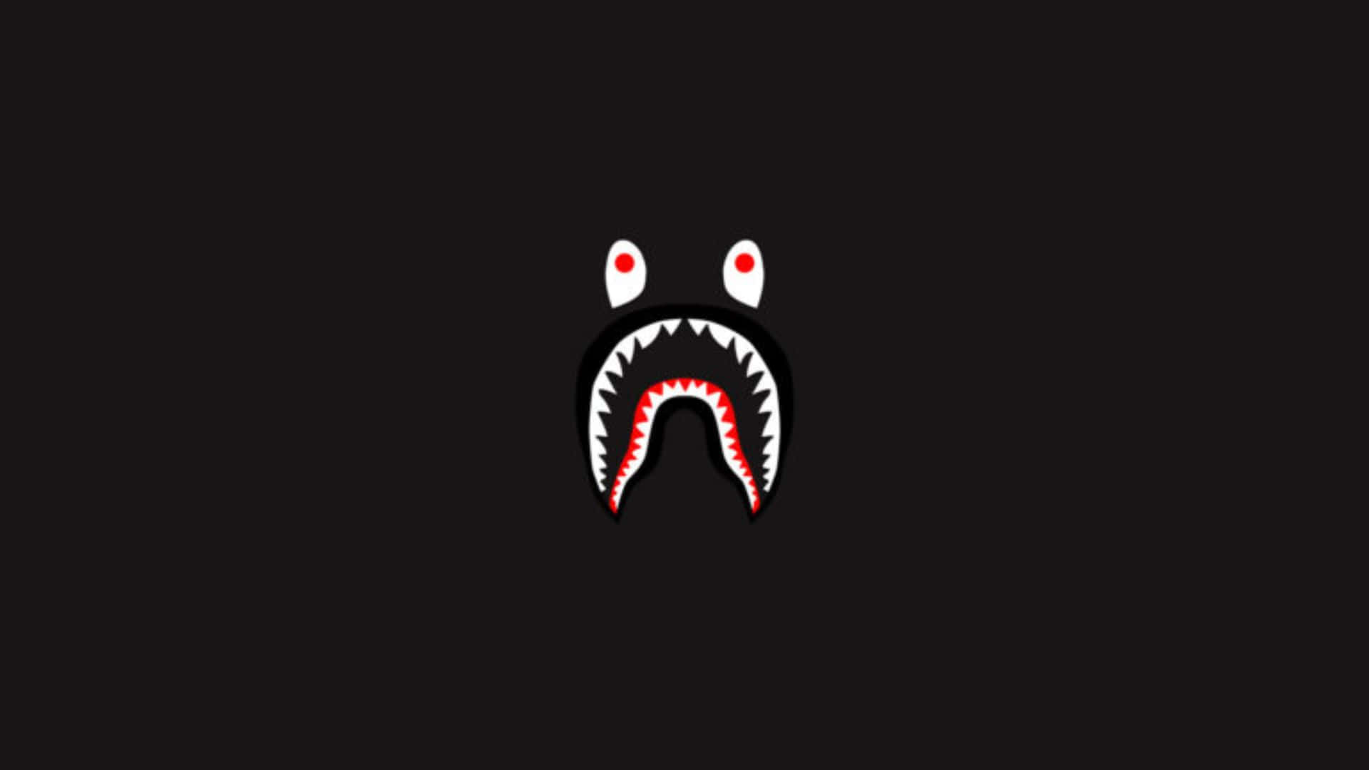 Unfondo Negro Con El Rostro De Un Tiburón Rojo Fondo de pantalla