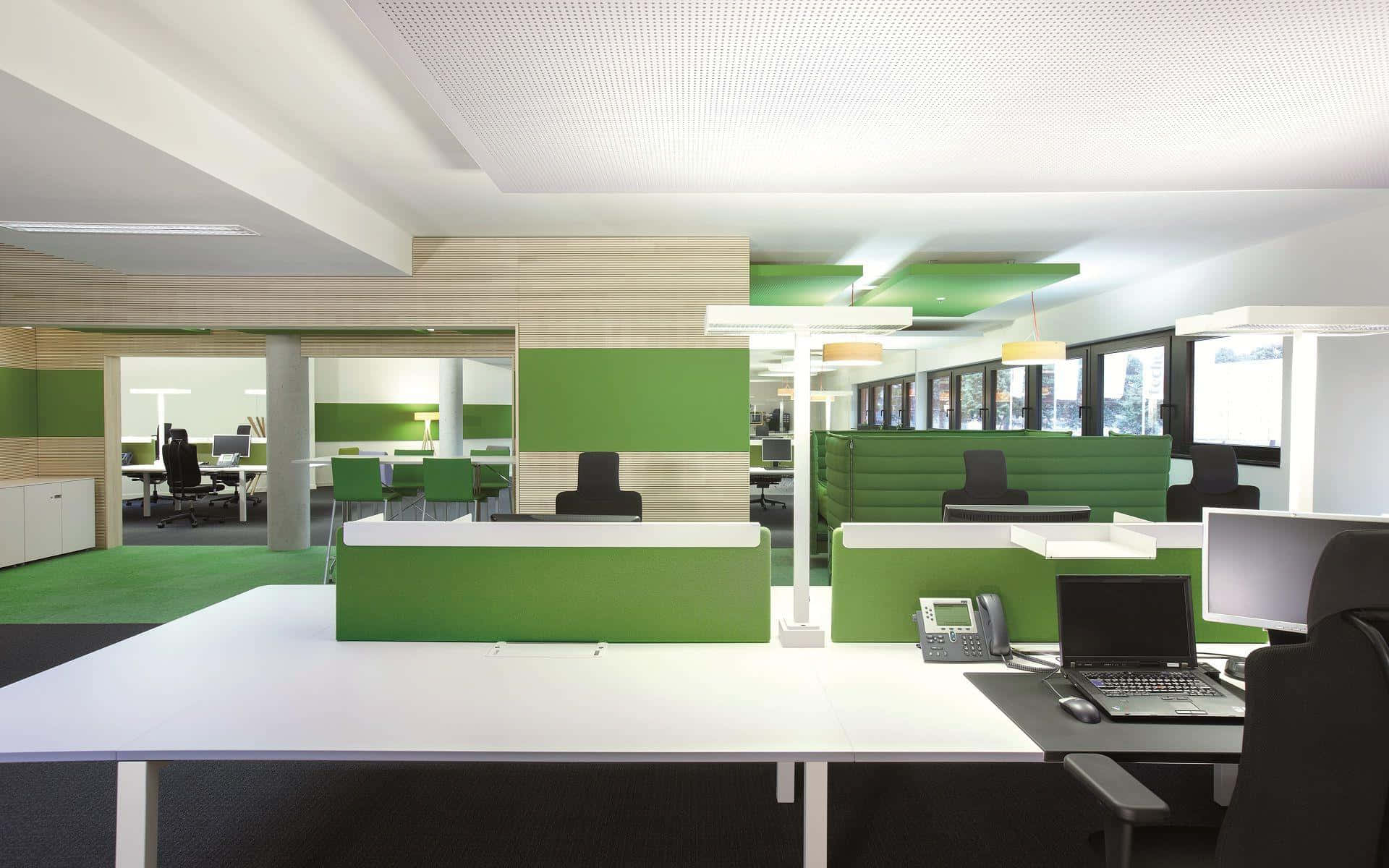 A Green And White Office With Desks And Chairs