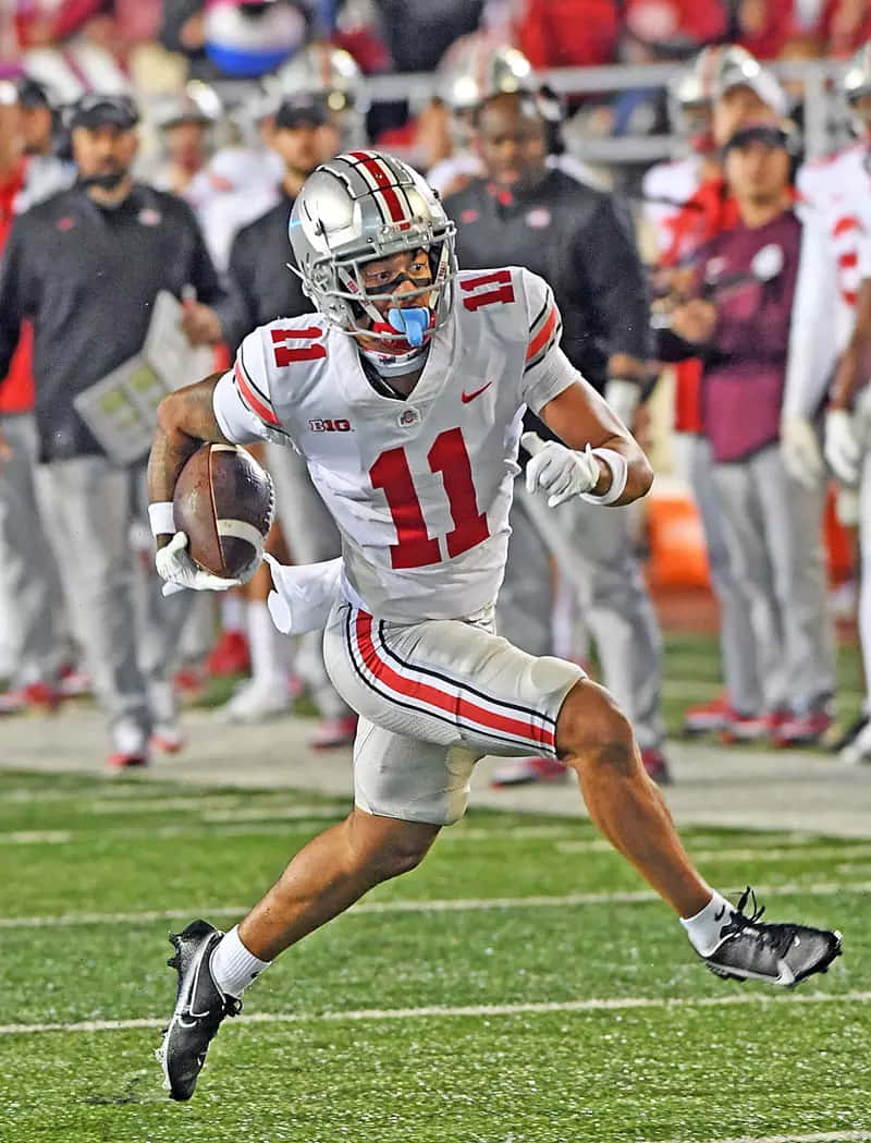 Download Ohio State Football Player Action Shot Wallpaper | Wallpapers.com