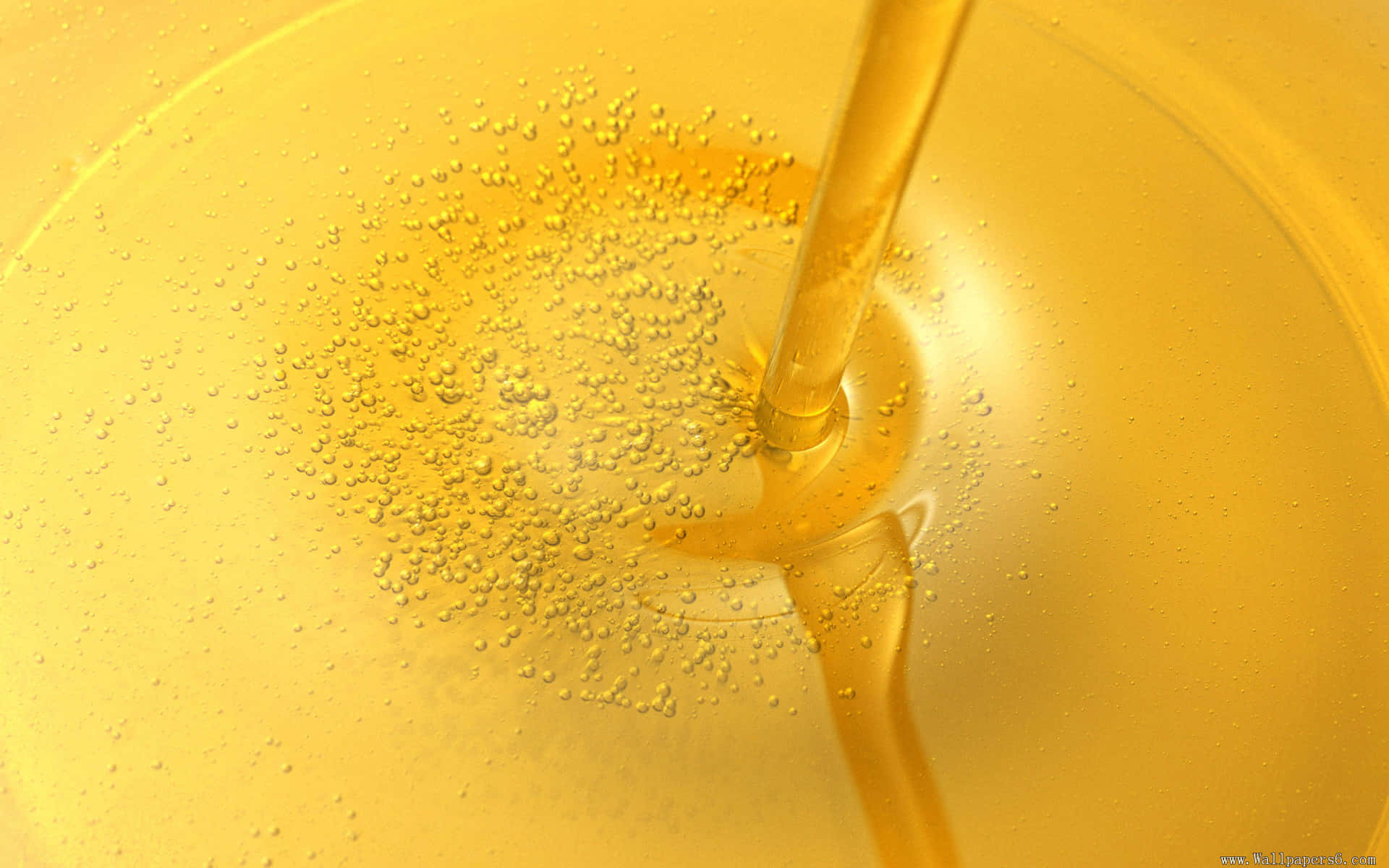 A Yellow Liquid Pouring Into A Bowl