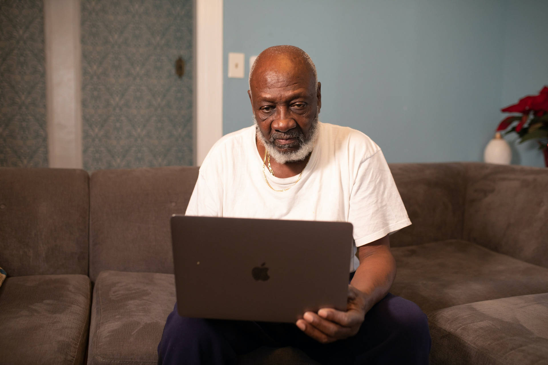 Old Black Man Using Laptop On Couch Picture