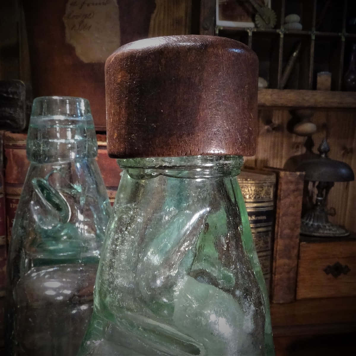 Two Glass Bottles With A Wooden Lid