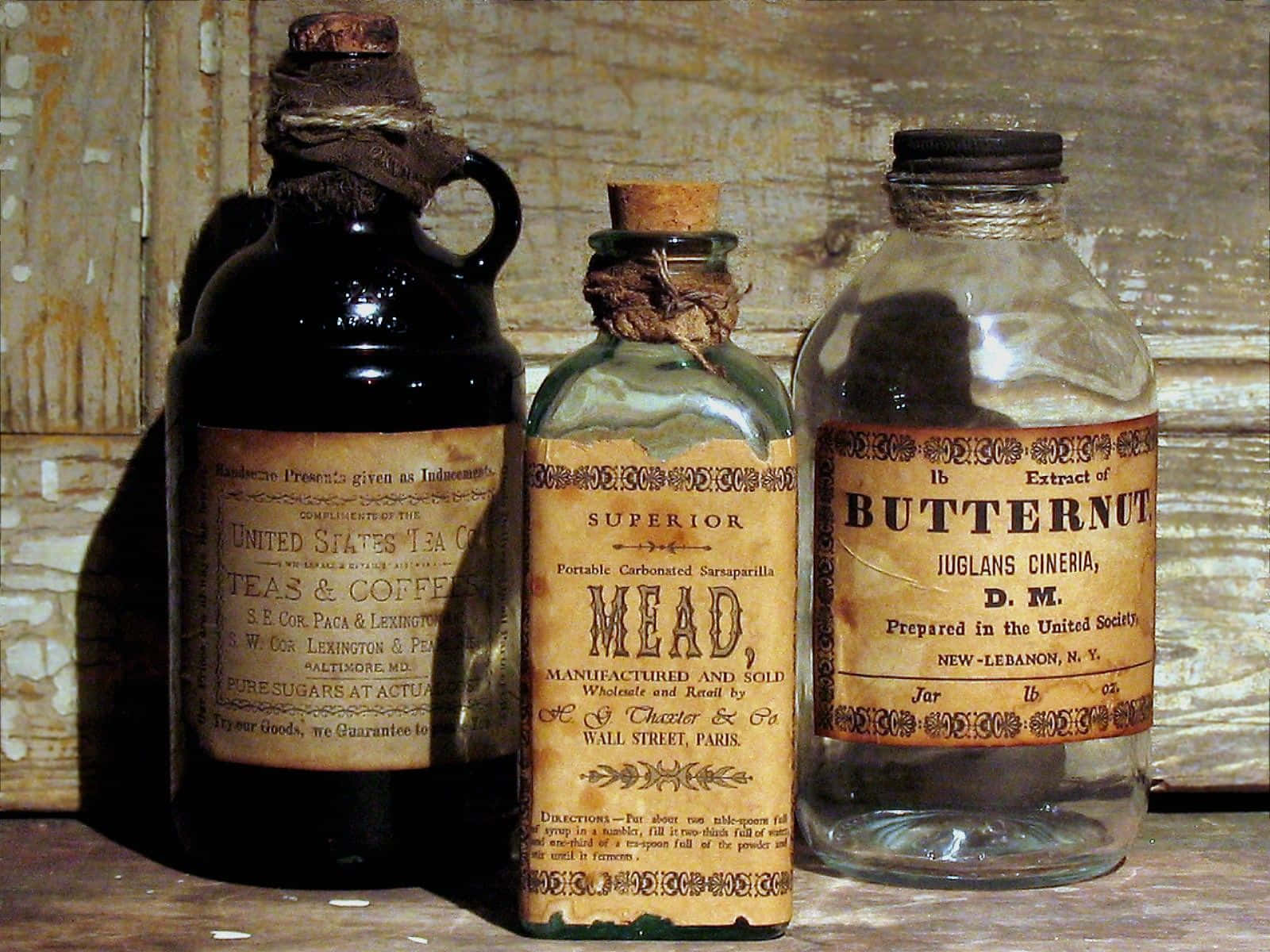 Three Old Bottles Of Medicine On A Wooden Table