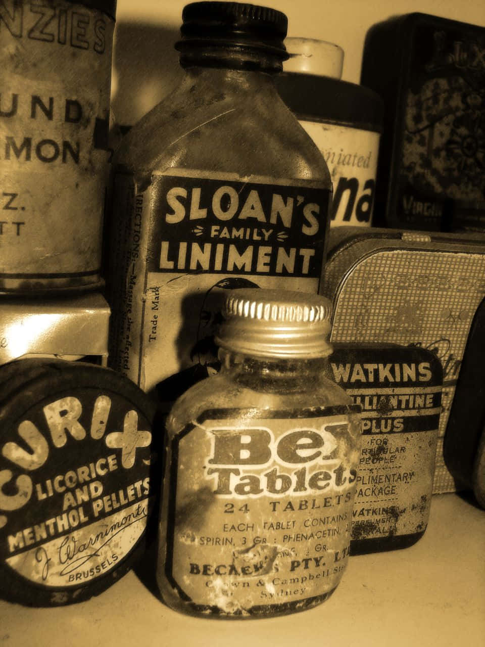 A Collection Of Old Bottles And Jars On A Shelf