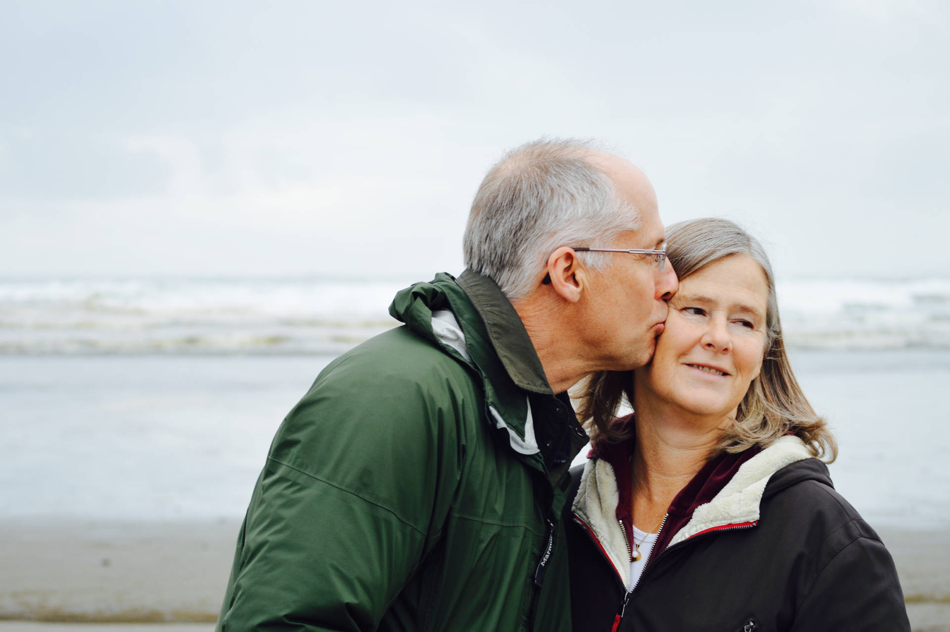 Old Couple Kiss By The Beach