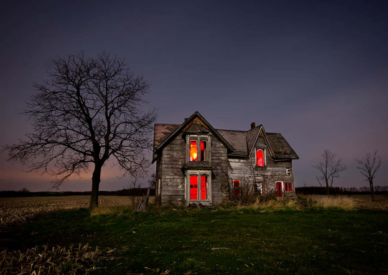 A House With Red Lights In The Middle Of A Field