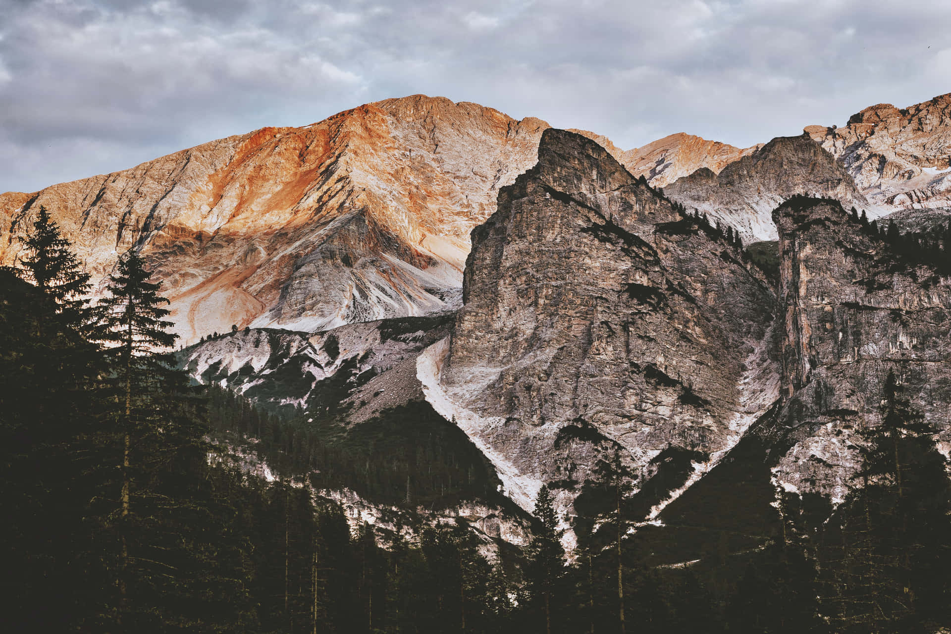 A Mountain Range With Trees In The Background Wallpaper