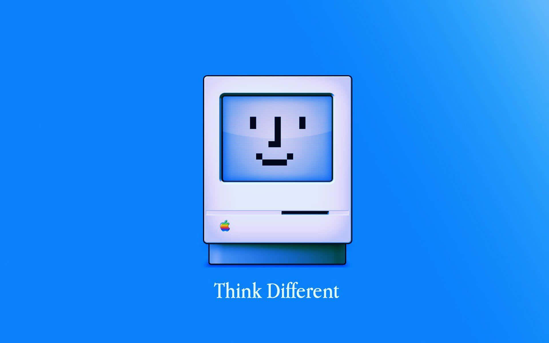 En computer med ordene Tænk anderledes på det. Wallpaper