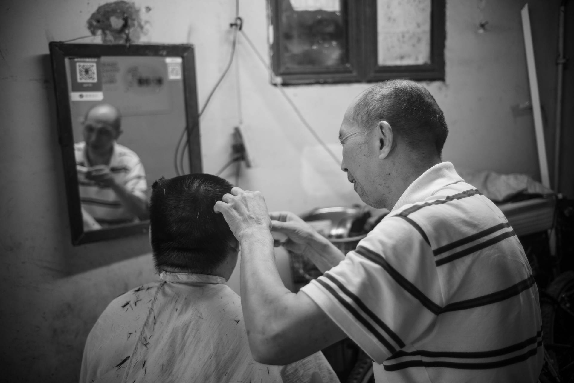 Old Man Performing Haircut