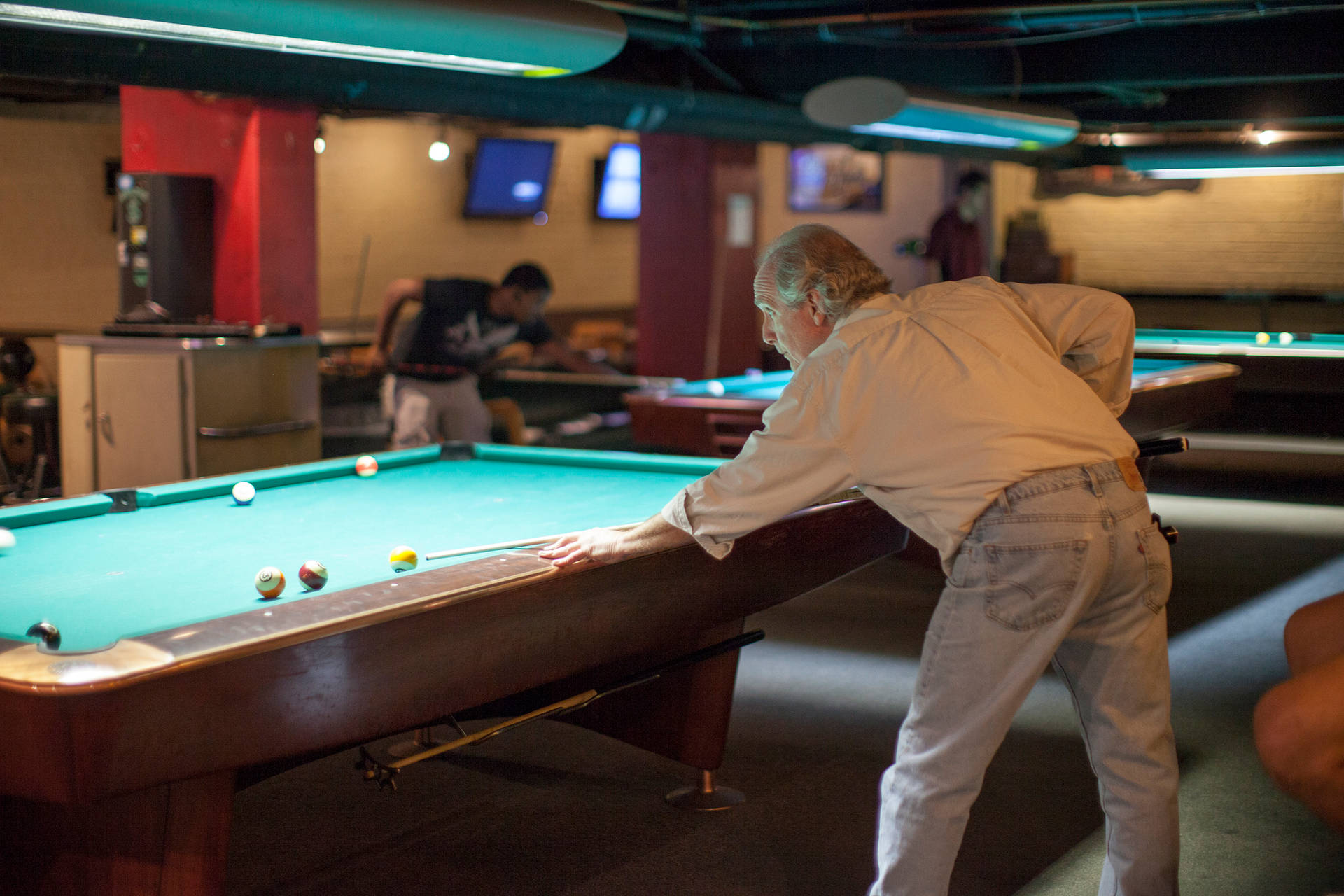 Old Man Playing Billiards At Bar Wallpaper