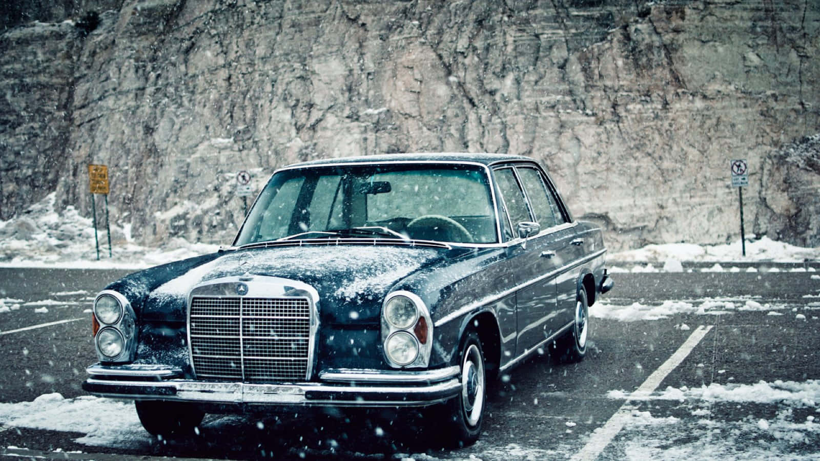 Majestic Old Mercedes Amidst the Snowy Mountains Wallpaper
