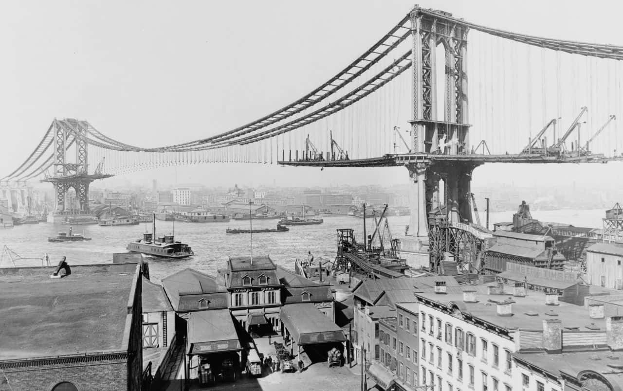 A Black And White Photo Of A Bridge Over A City Wallpaper
