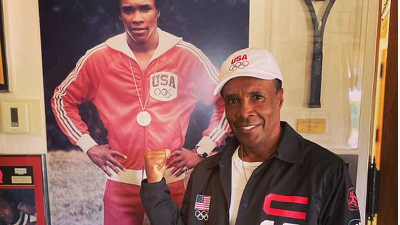Old Ray Leonard Posing With Photo Of Himself Wallpaper