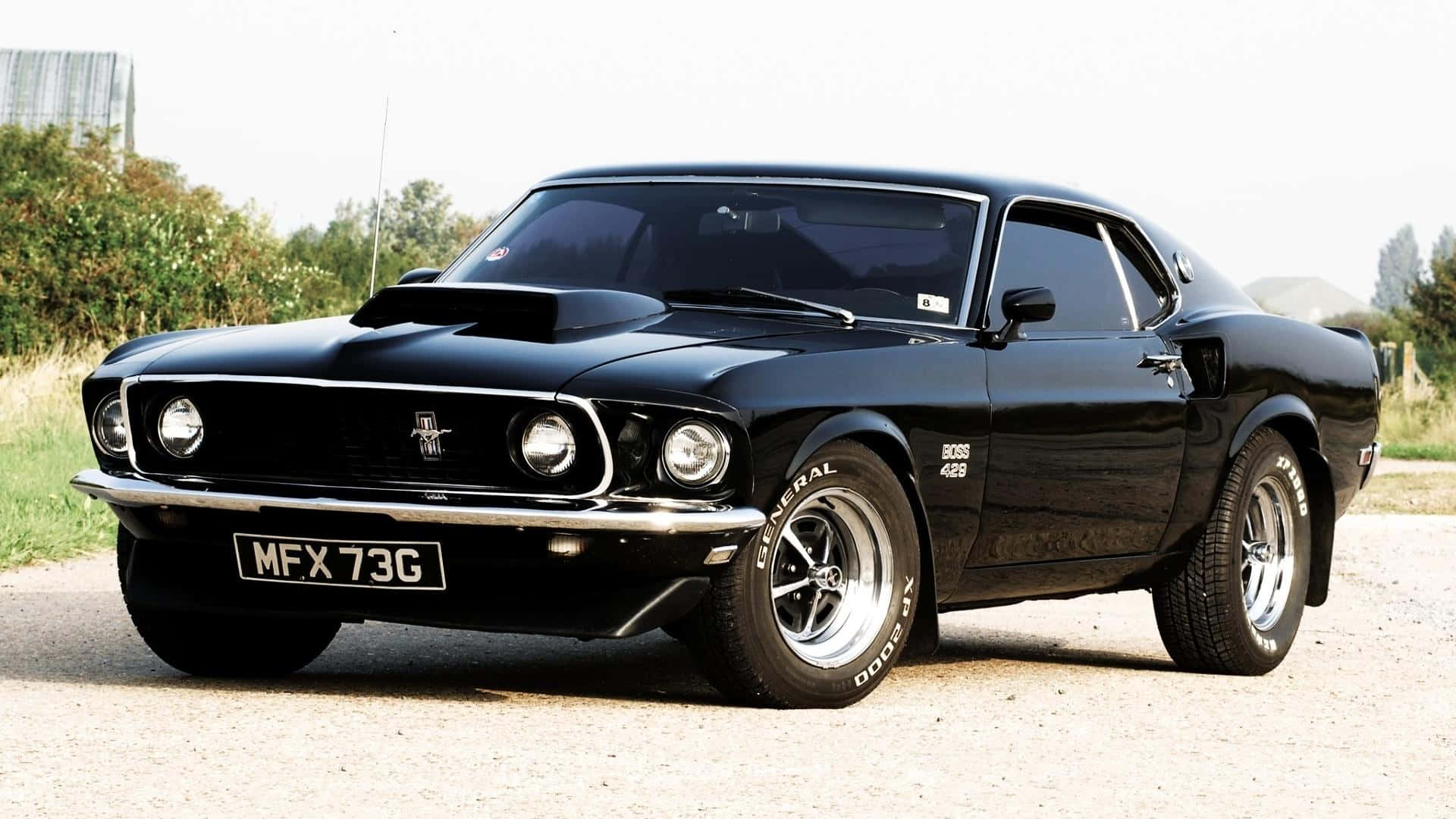 A Black Mustang Parked On A Dirt Road Wallpaper