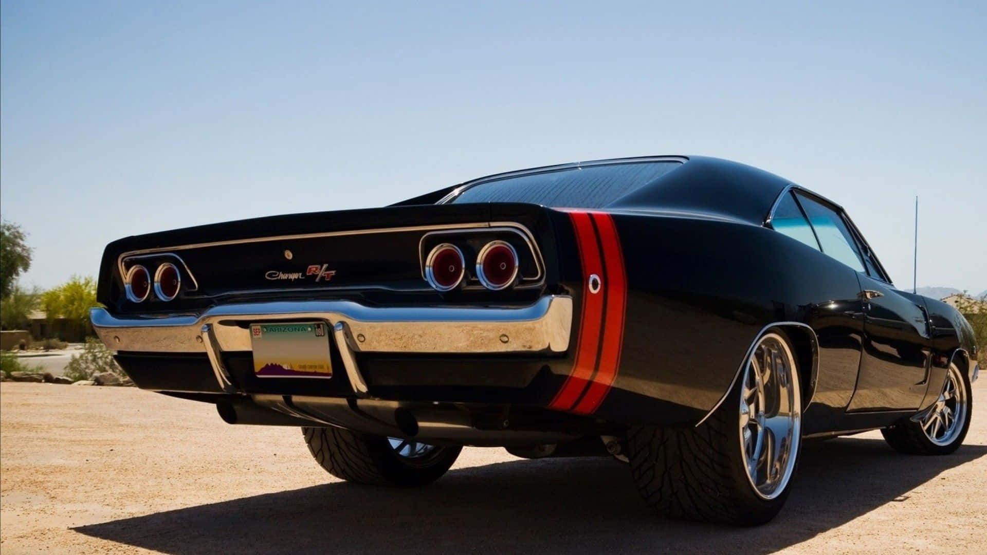 A Black Muscle Car Parked In The Desert Wallpaper