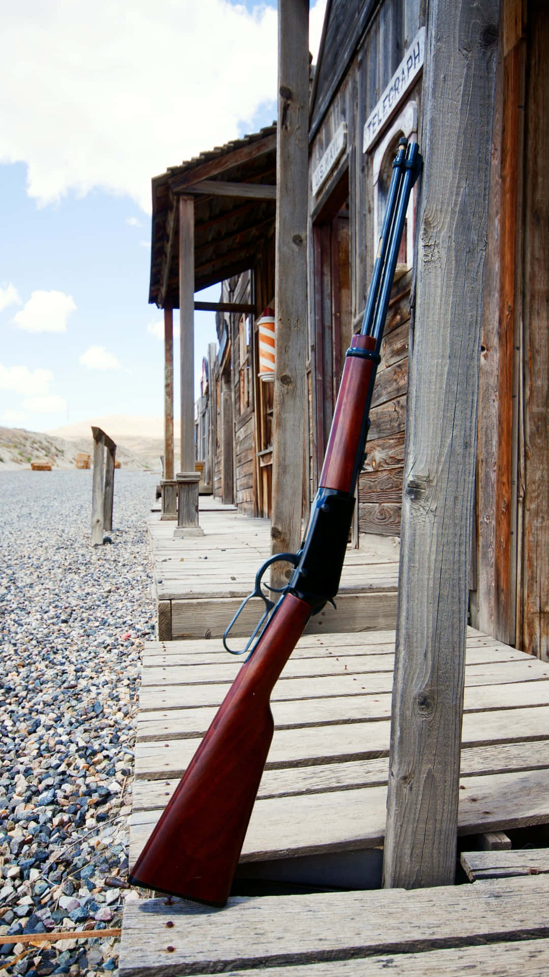 Old Western Rifle Leaning Against Building.jpg Wallpaper