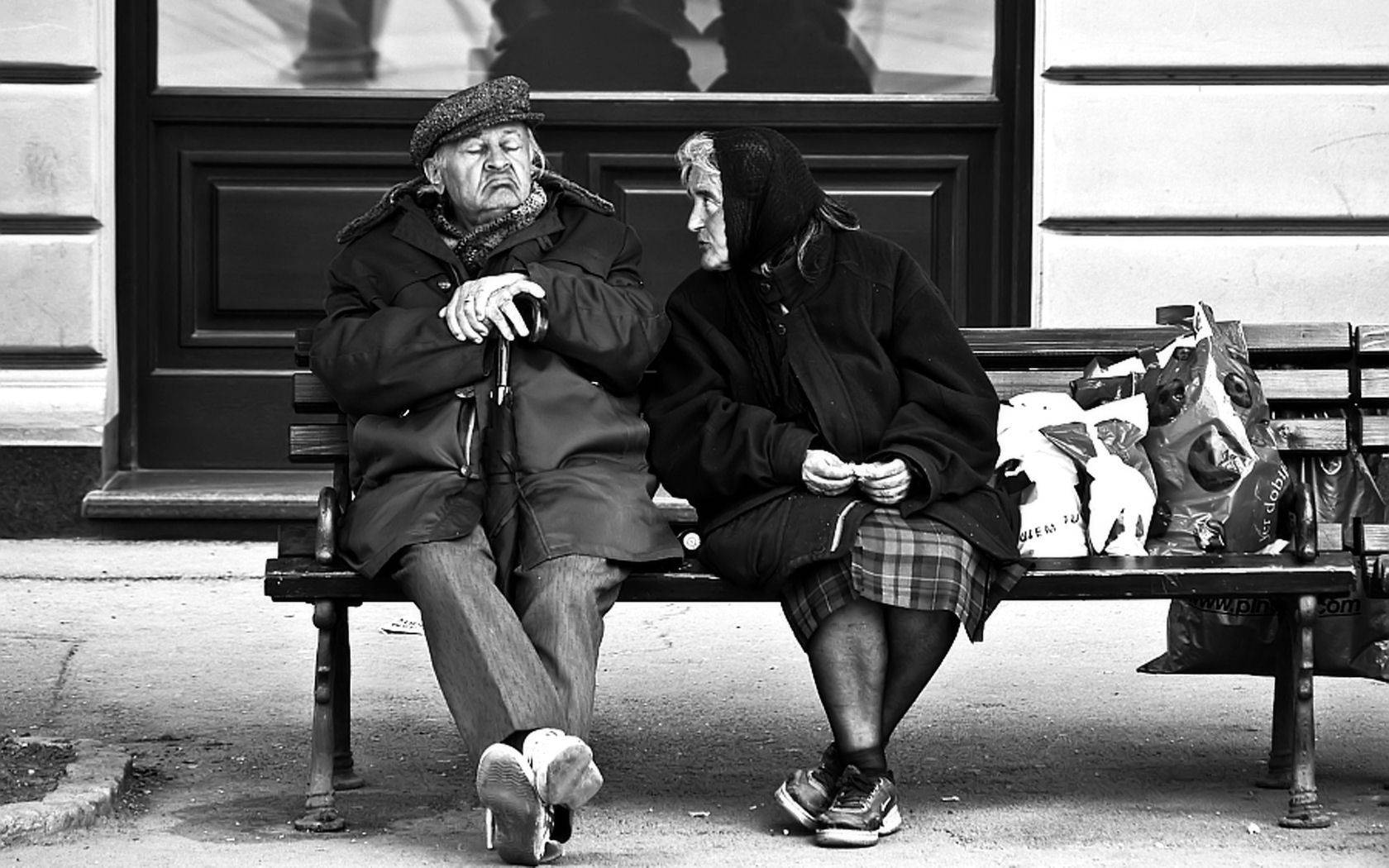 Old Woman And Man In The Waiting Station Wallpaper