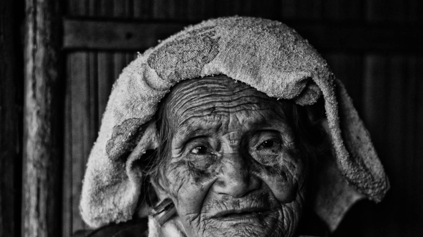 Old Woman With A Towel Over Her Head Wallpaper
