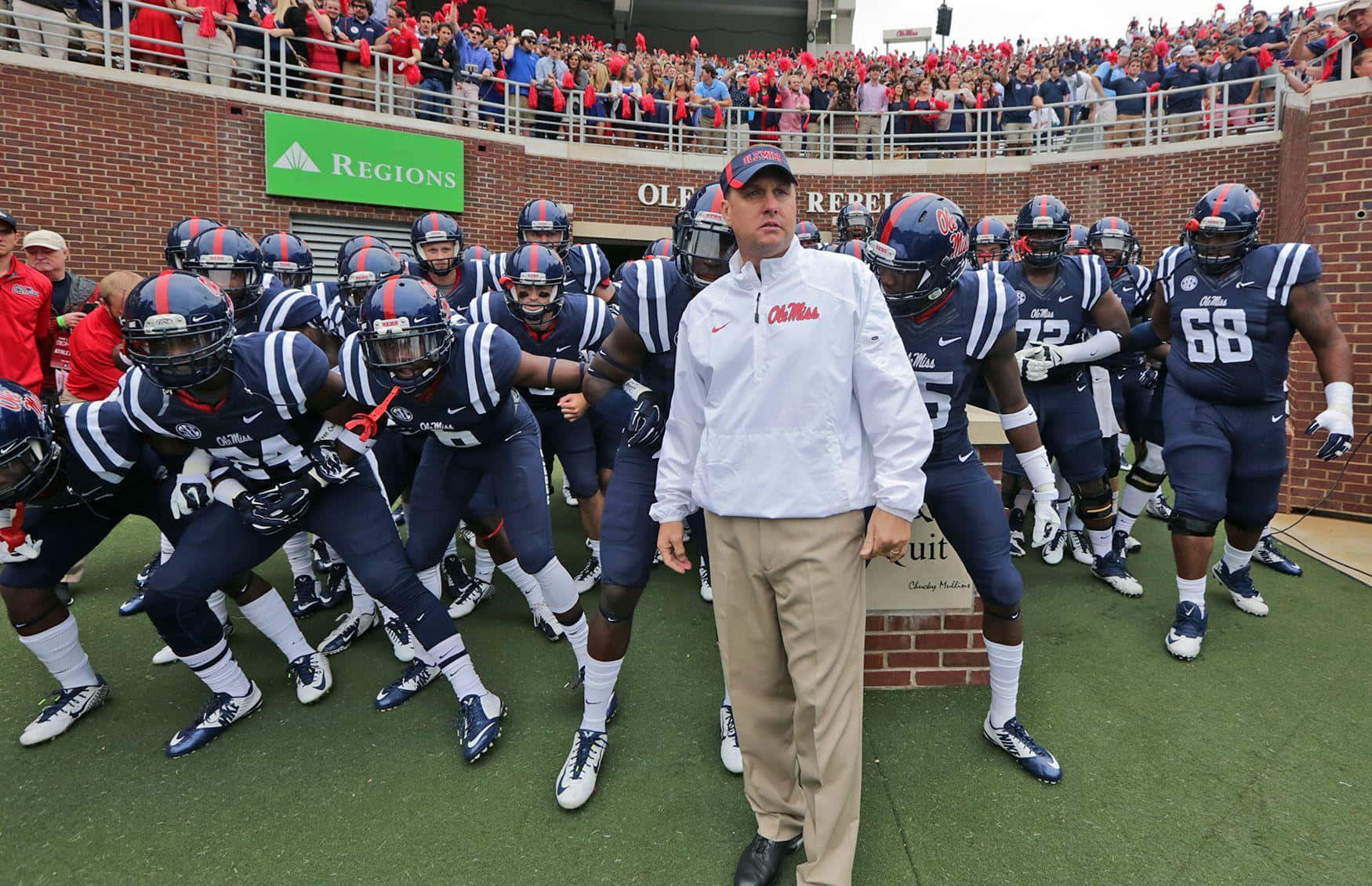 Ole Miss Coach With Players Wallpaper
