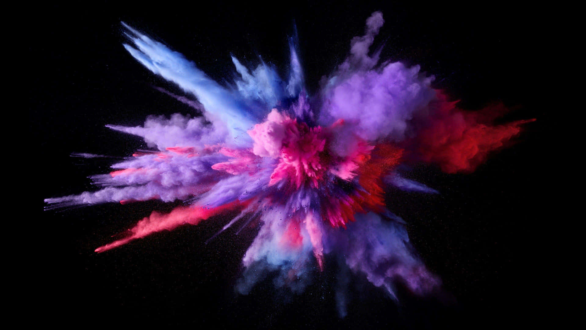 A Colorful Powder Explosion On A Black Background Wallpaper