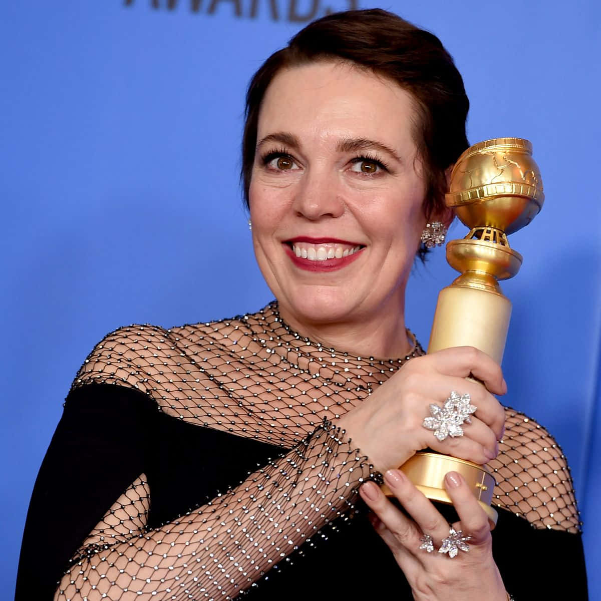 Olivia Colman Glowing Radiantly At A Red Carpet Event Wallpaper