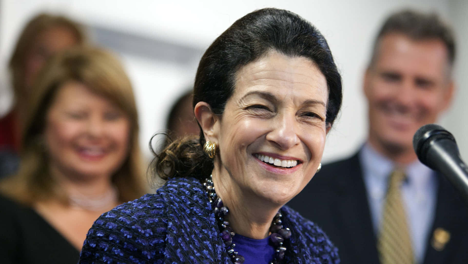 Olympia Snowe Smiling With Microphone Wallpaper