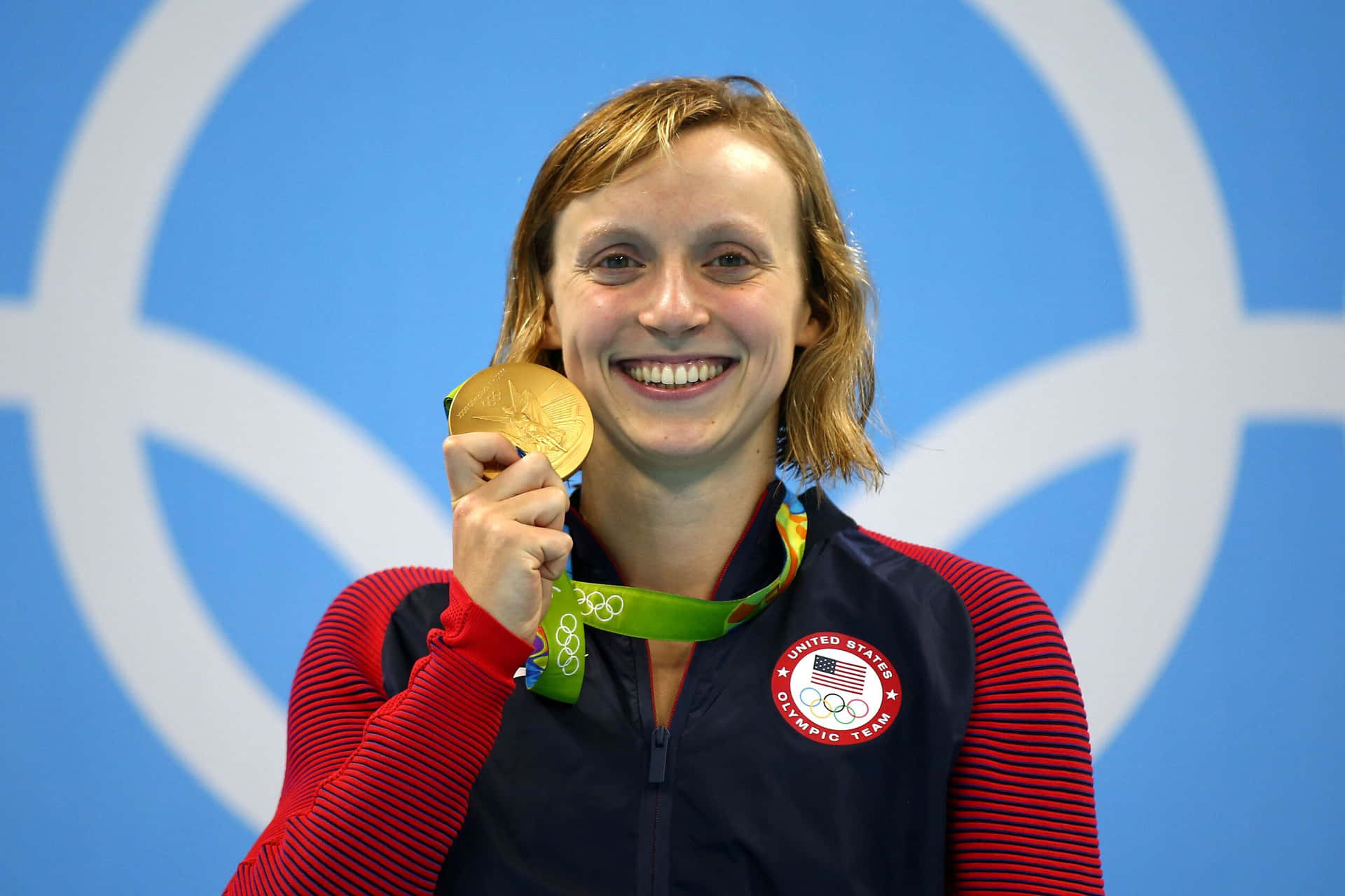 Olympic Swimmer Gold Medal Celebration Wallpaper