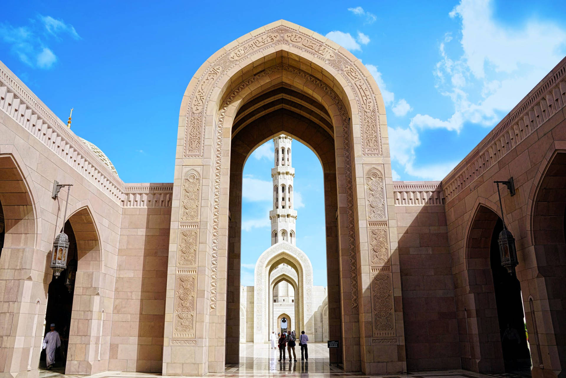 Caption: Magnificent Muscat Mosque Under a Blue Omani Sky Wallpaper