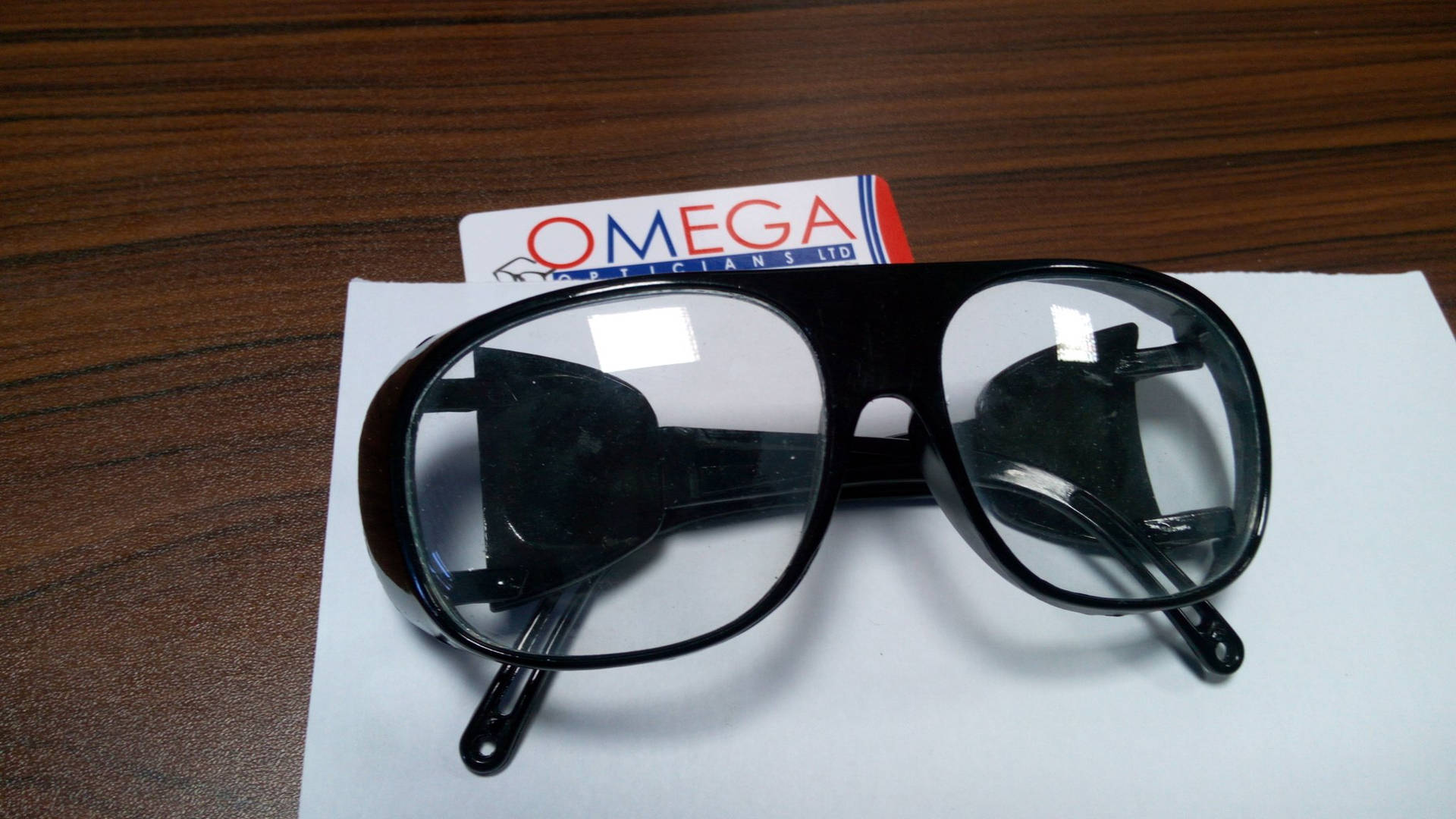 Omega Opticians Glasses Thick Black Frames Wallpaper