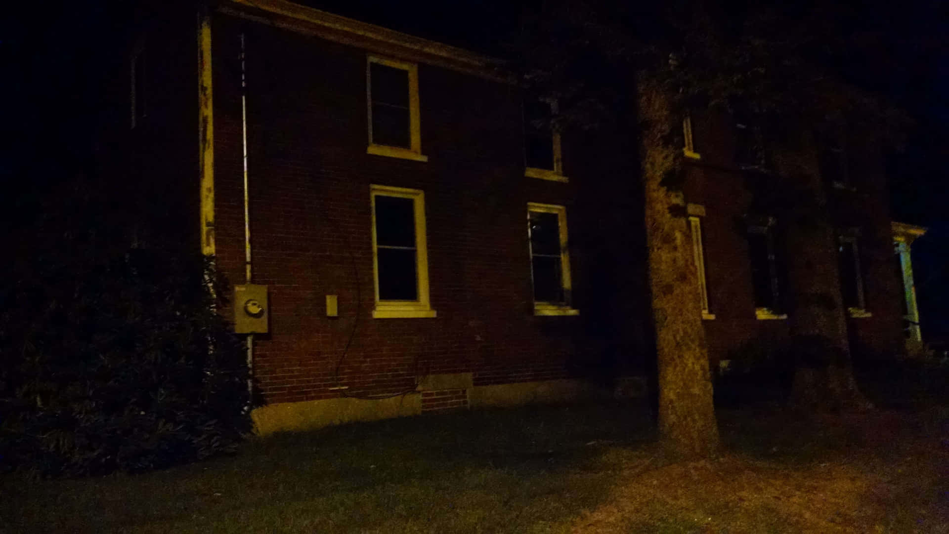 Ominous House Exterior At Night Wallpaper