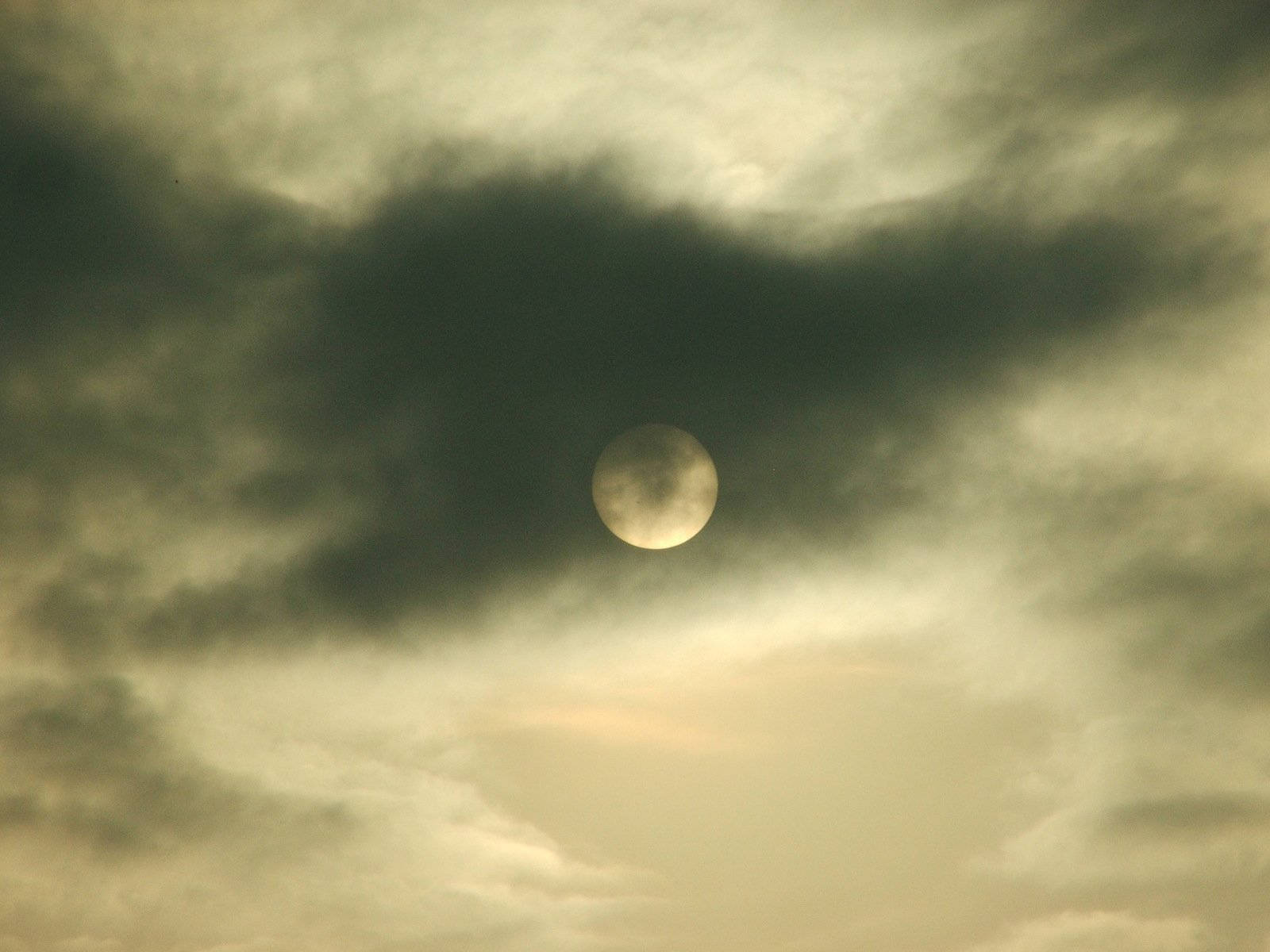 Ominous Moon Behind Dark Clouds Wallpaper