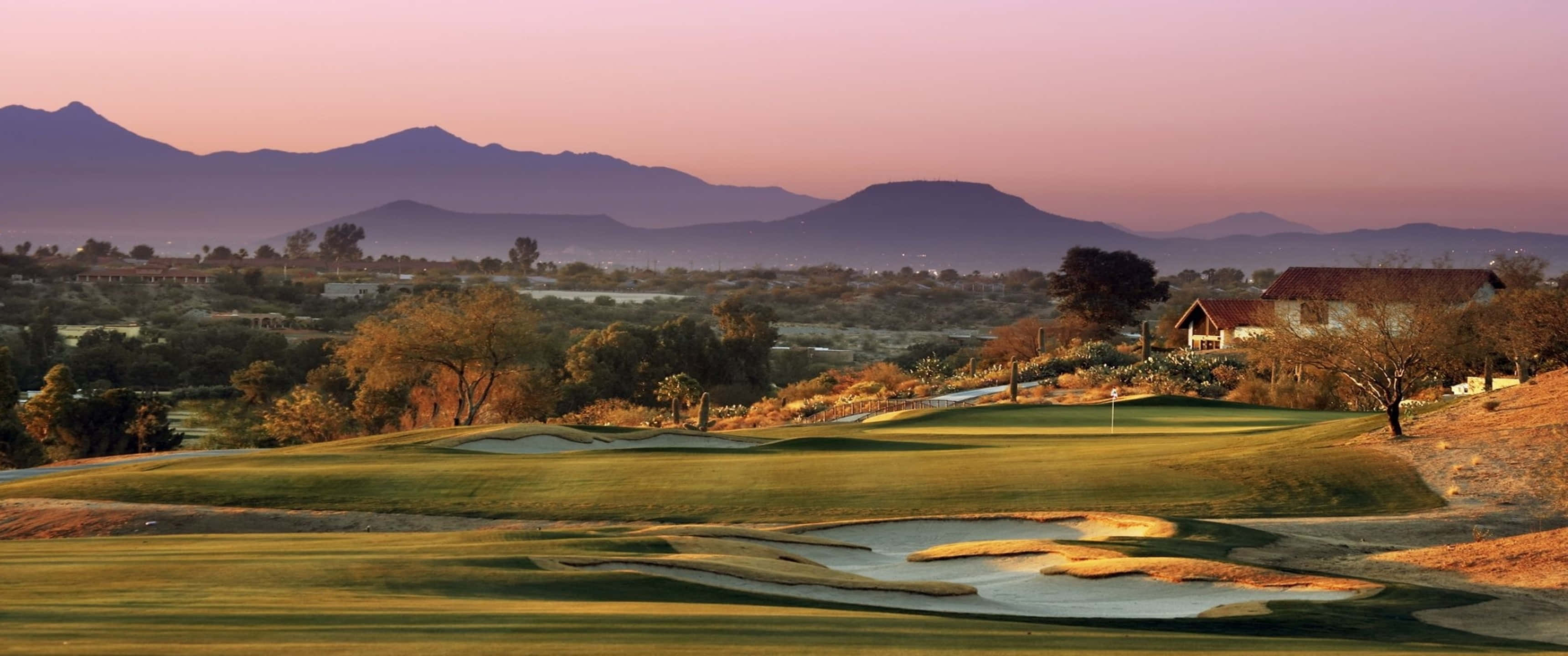 Caption: Scenic Omni Tucson Golf Course Landscape at Dusk