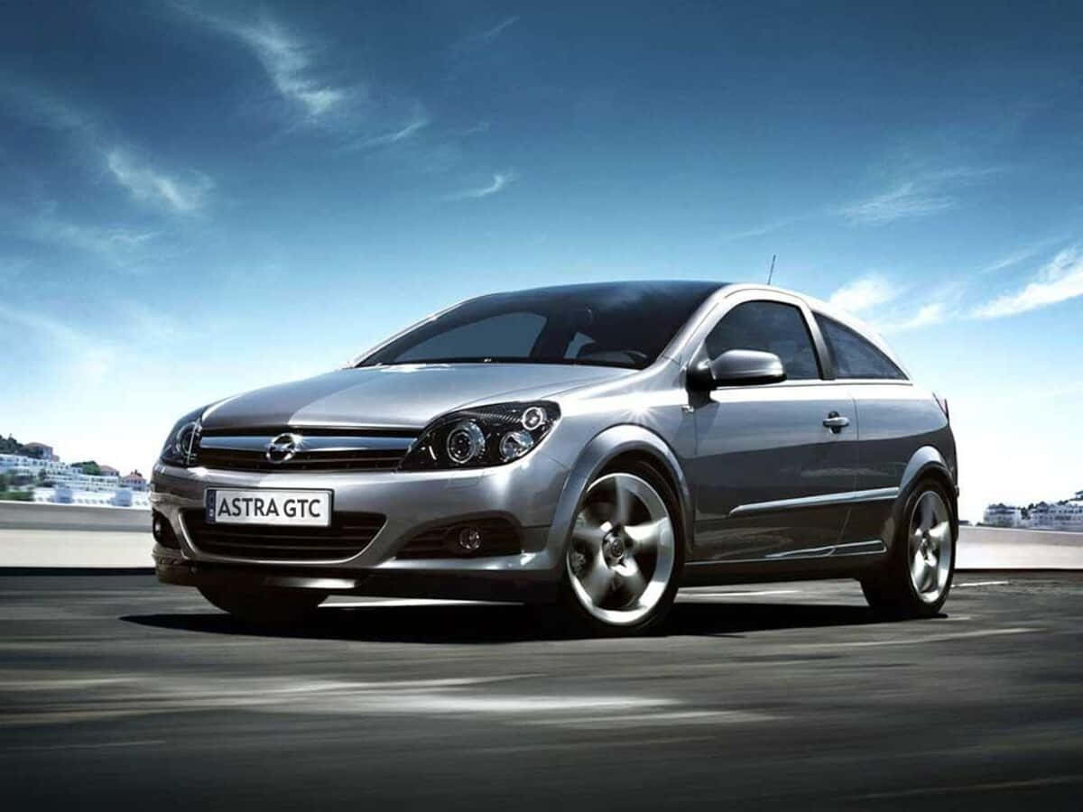 Sleek Opel Astra in action on the road Wallpaper