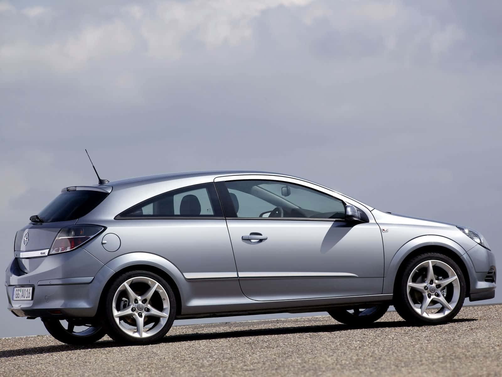 Sleek and stylish Opel Astra driving on the open road. Wallpaper