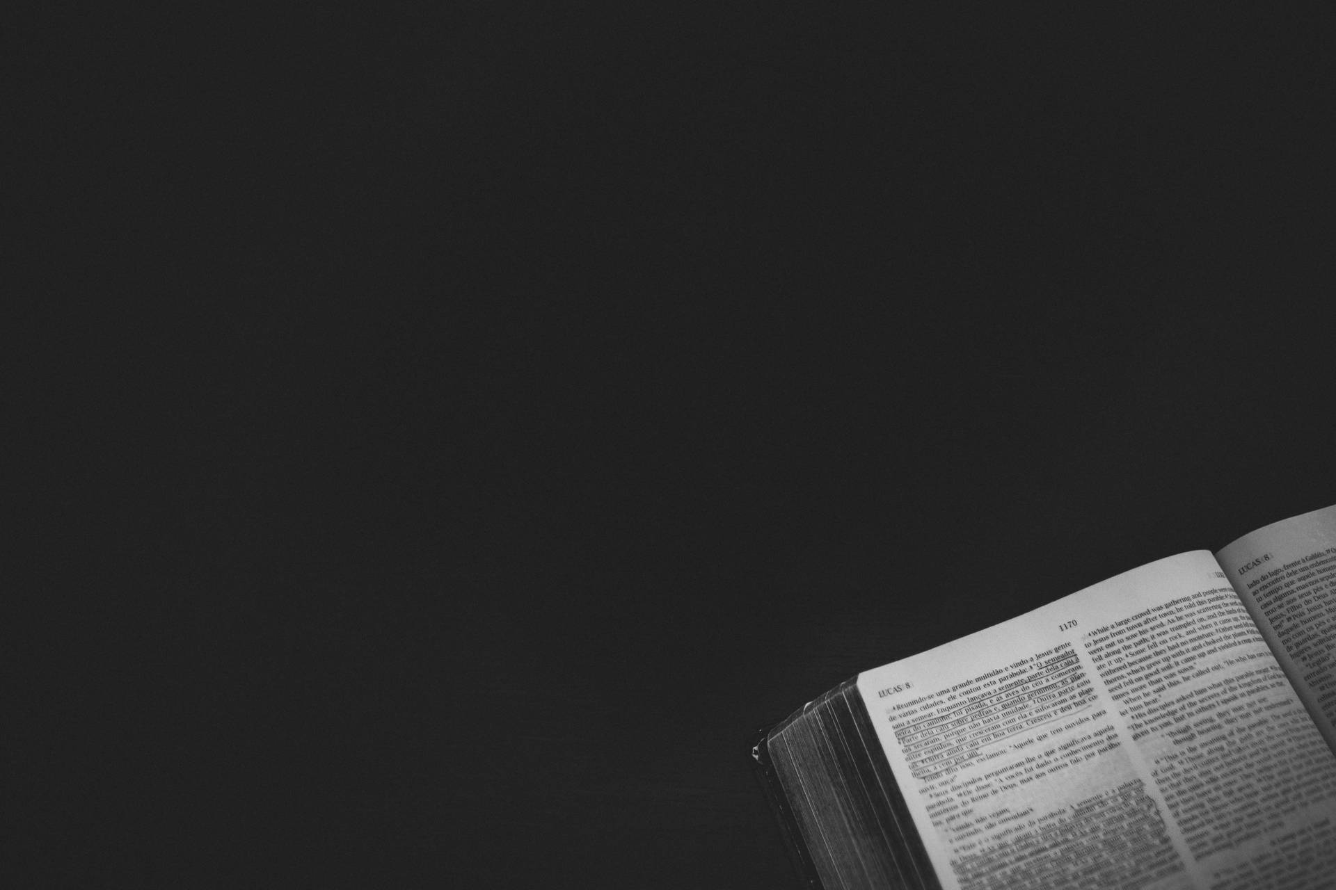 Open Bible on a Black Background Wallpaper