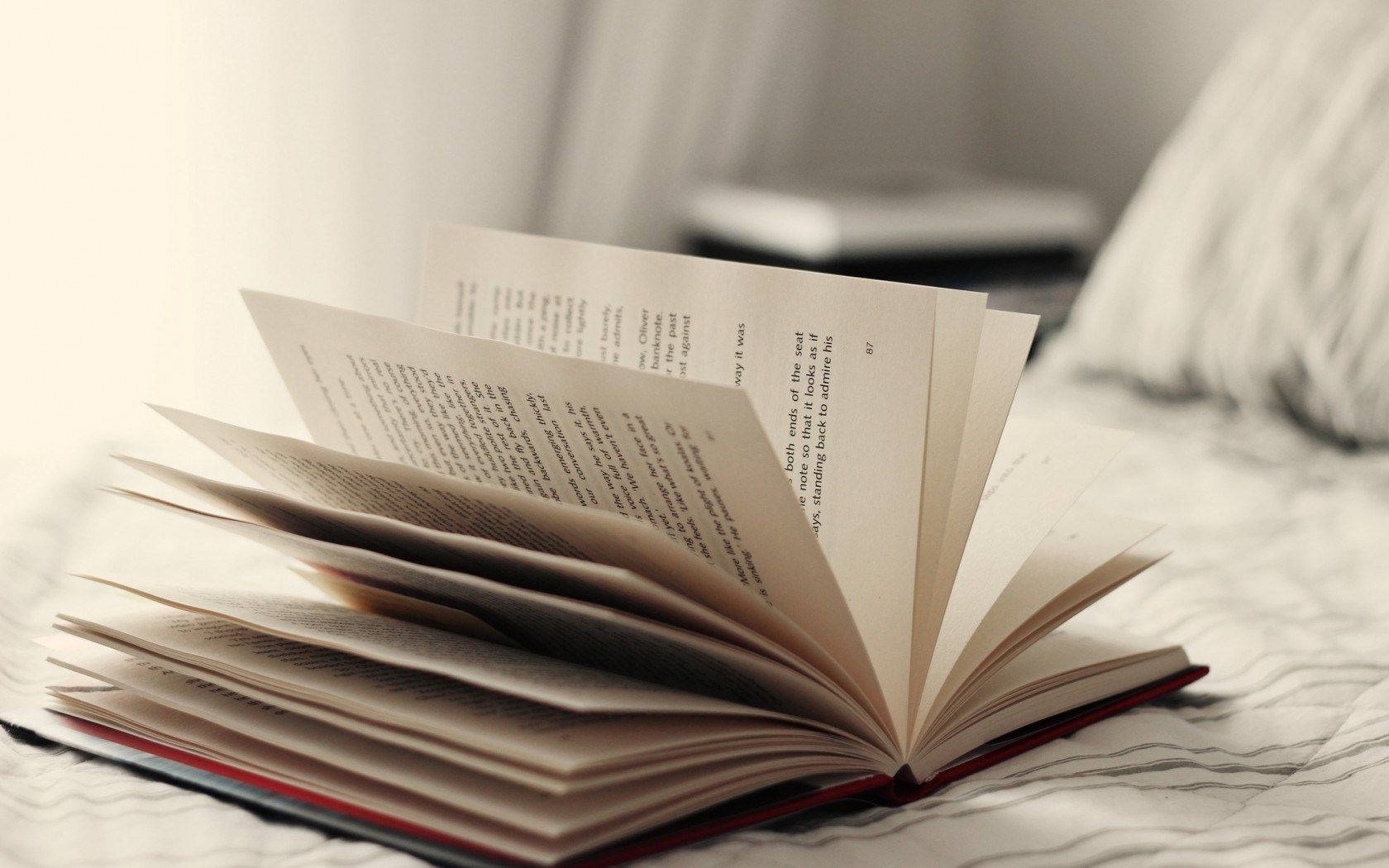 Open book pages place on bed wallpaper