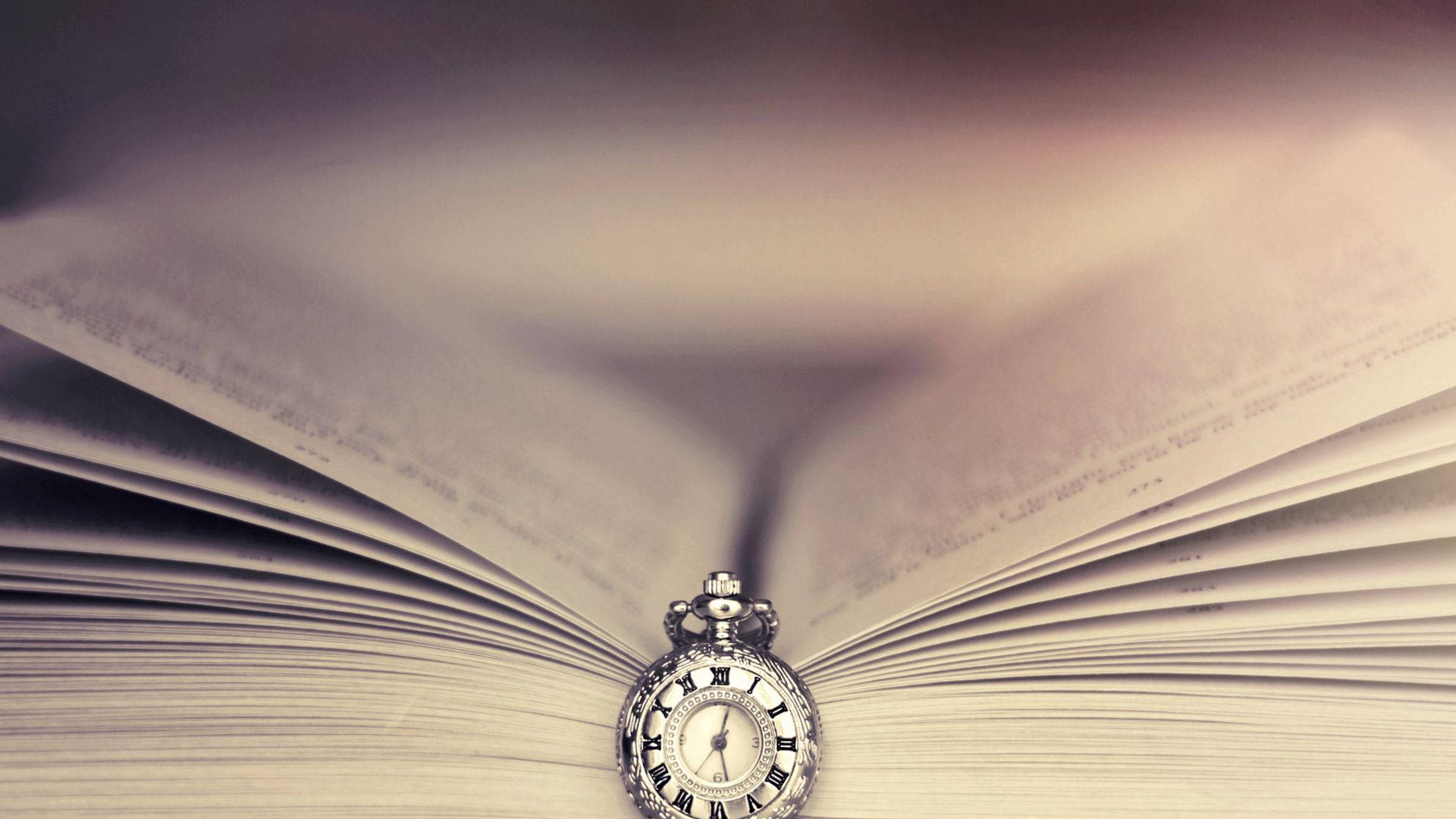 Open book with a pocketwatch as bookmark wallpaper
