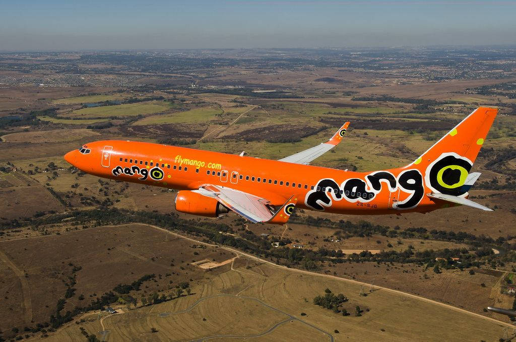 Orange Airplane Mango Airlines Cityscape Wallpaper