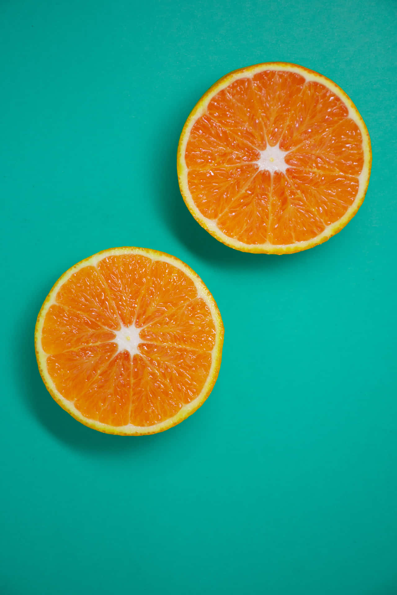 Two Slices Of Orange And Teal Wallpaper