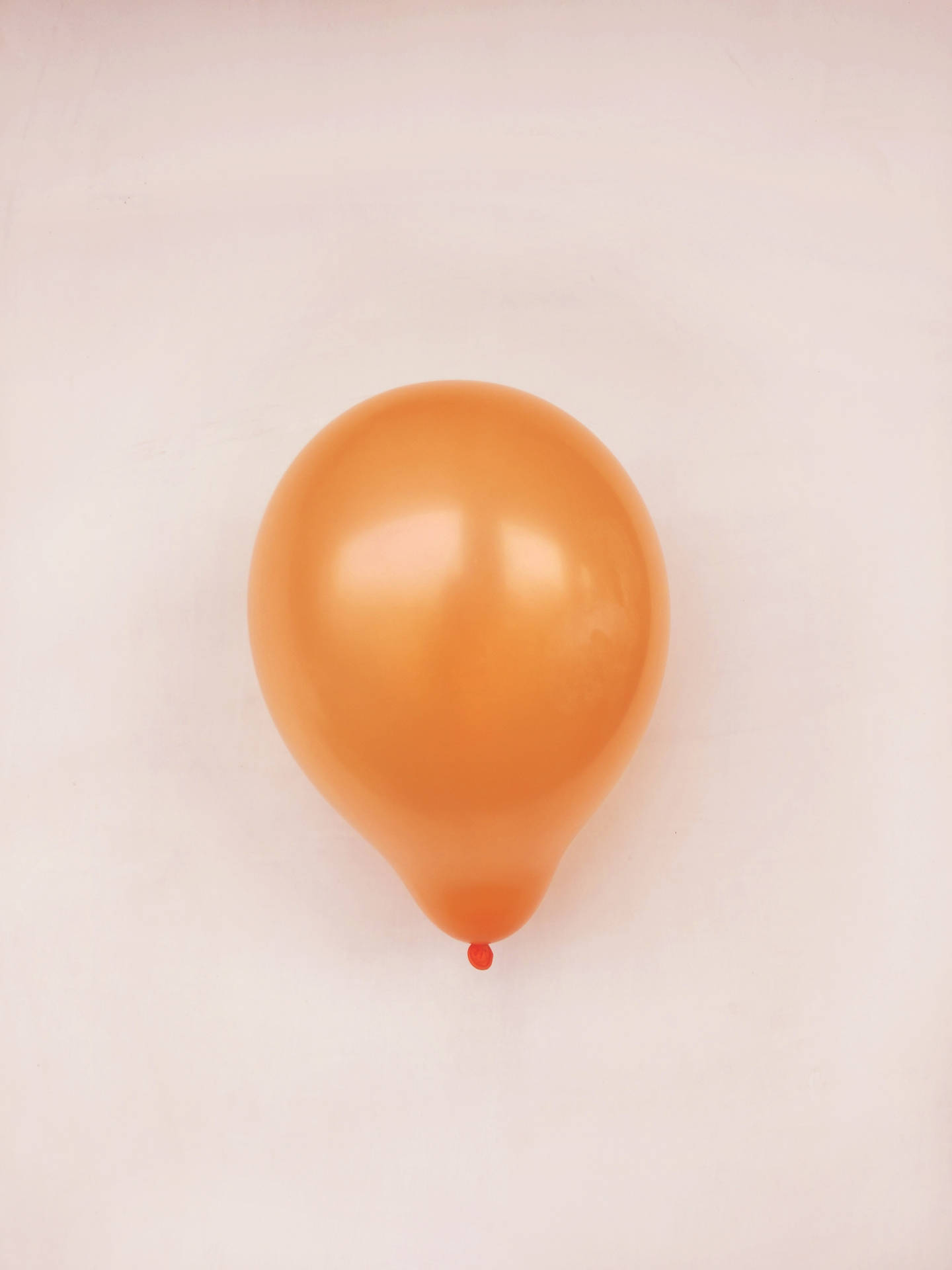 Orange Balloon In Beige Background Wallpaper