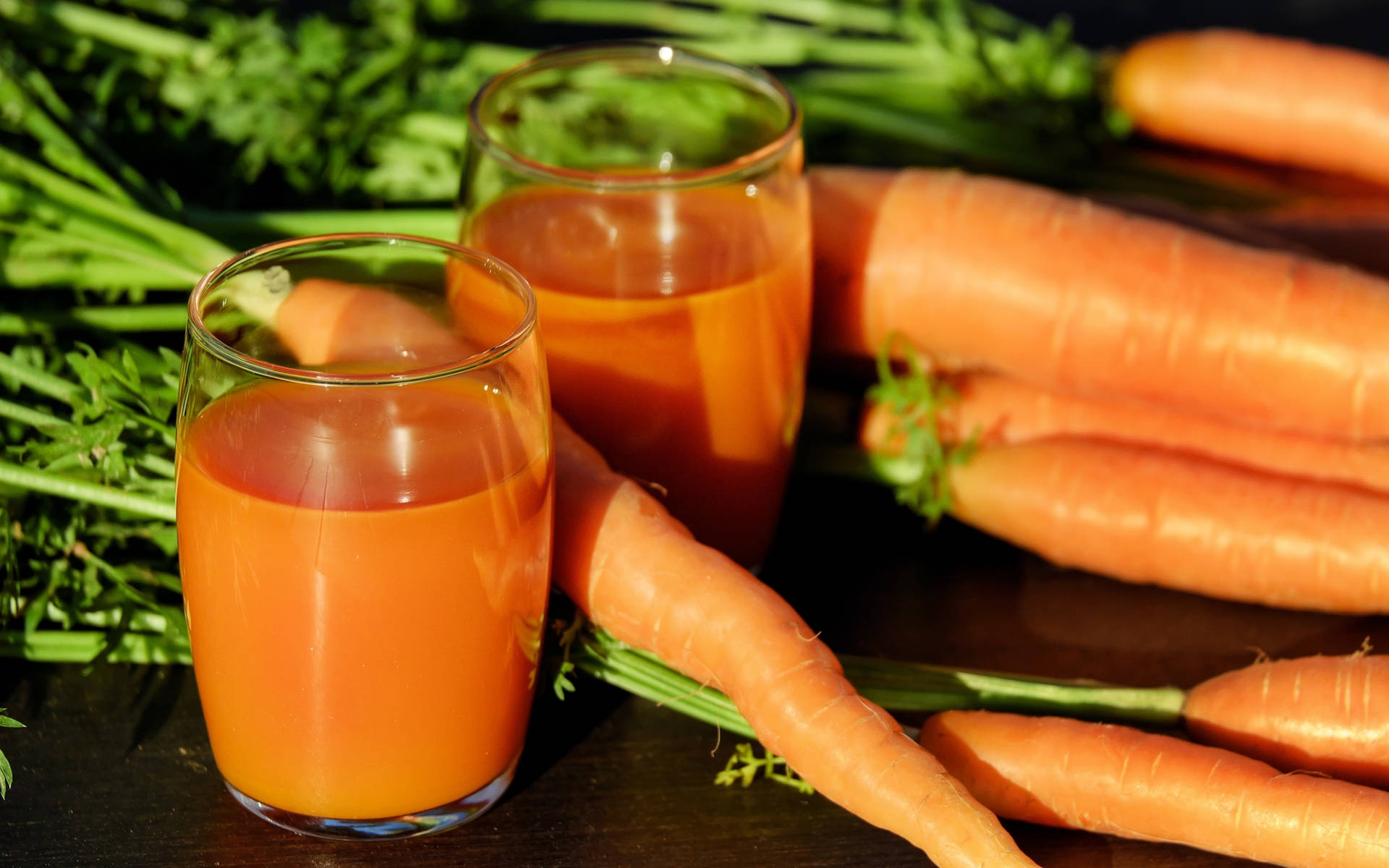 Refreshing Carrot Juice with Freshly Harvested Leaves Wallpaper