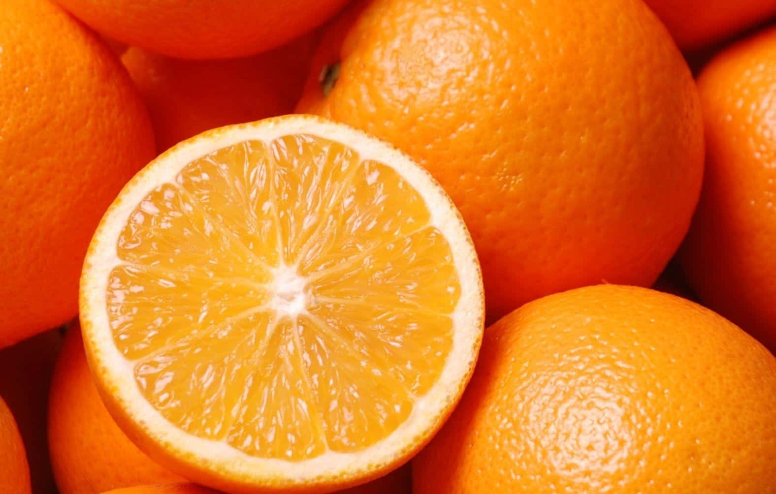 Fresh oranges with a vibrant orange background